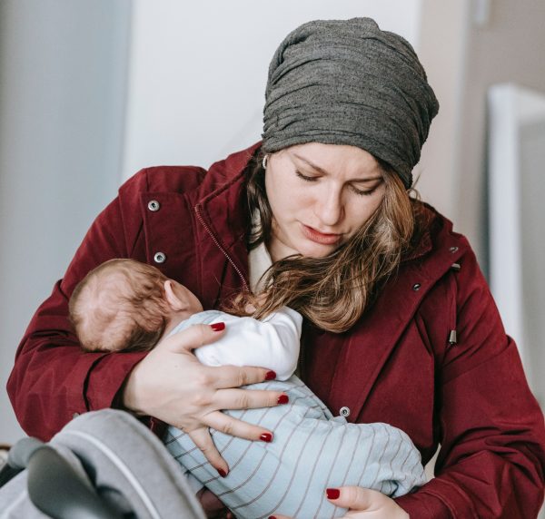 Woman nursing her baby in the cold 