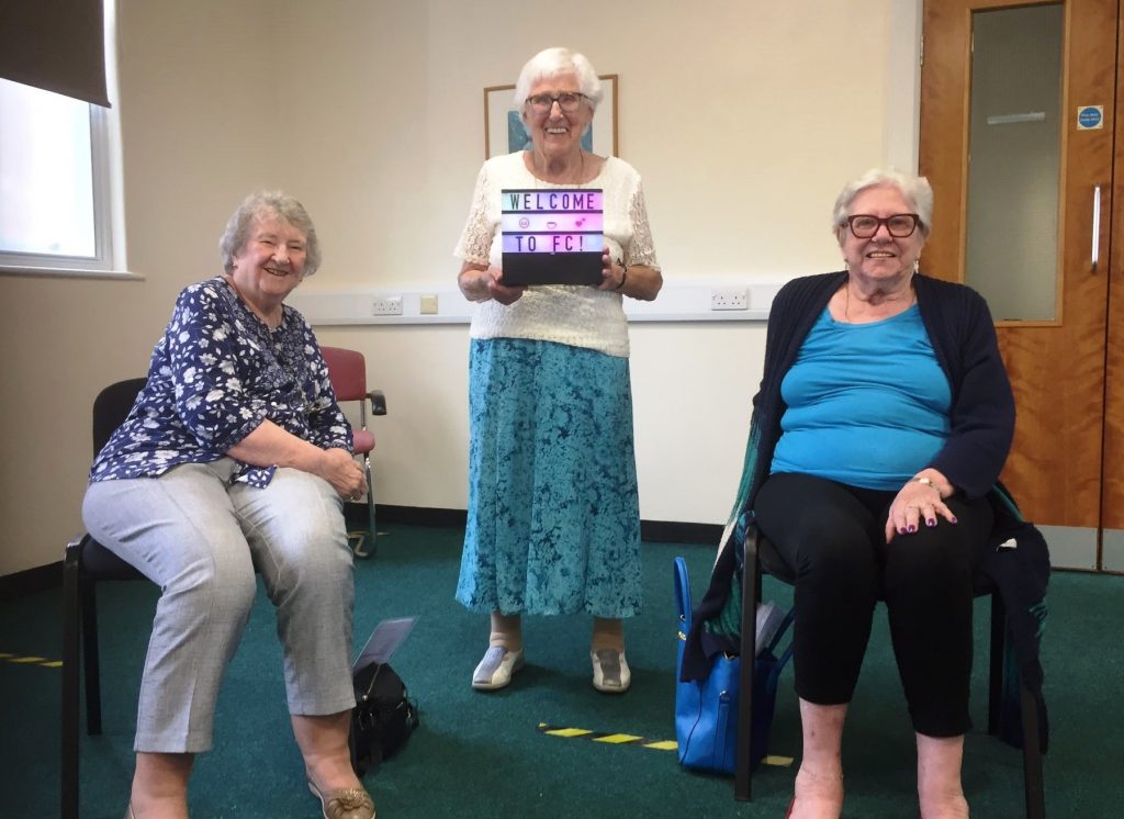 Three older women at a Friendship club