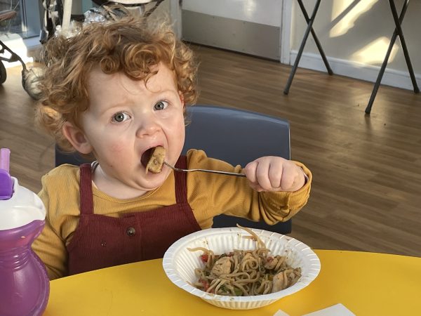 Little girl eating a big bowel of spaghetti