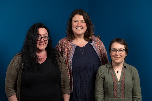 Three women standing together