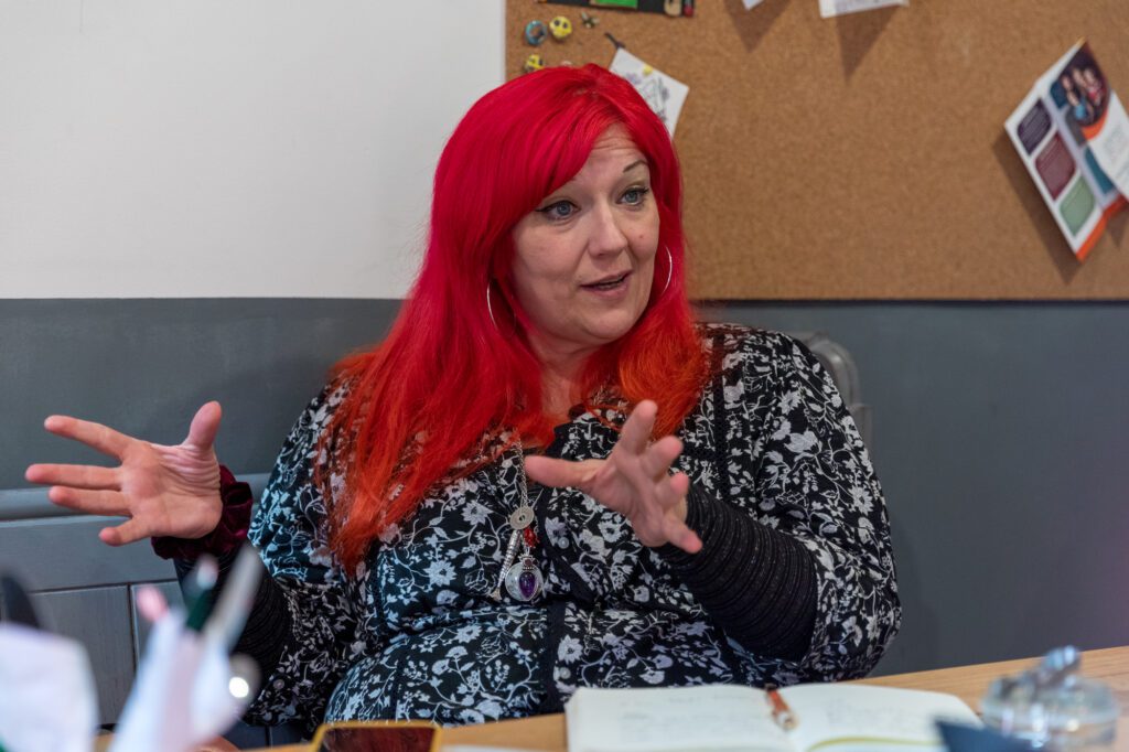 Photo of Director of Flash Company Arts, Whitby Women with red hair using her hands to explain something