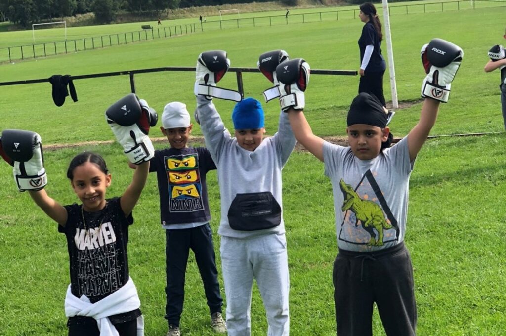 Picture of children celebrating with hands up in the air 