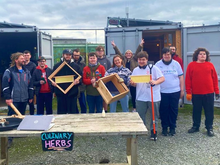 image of young people outside a container showing bee kit