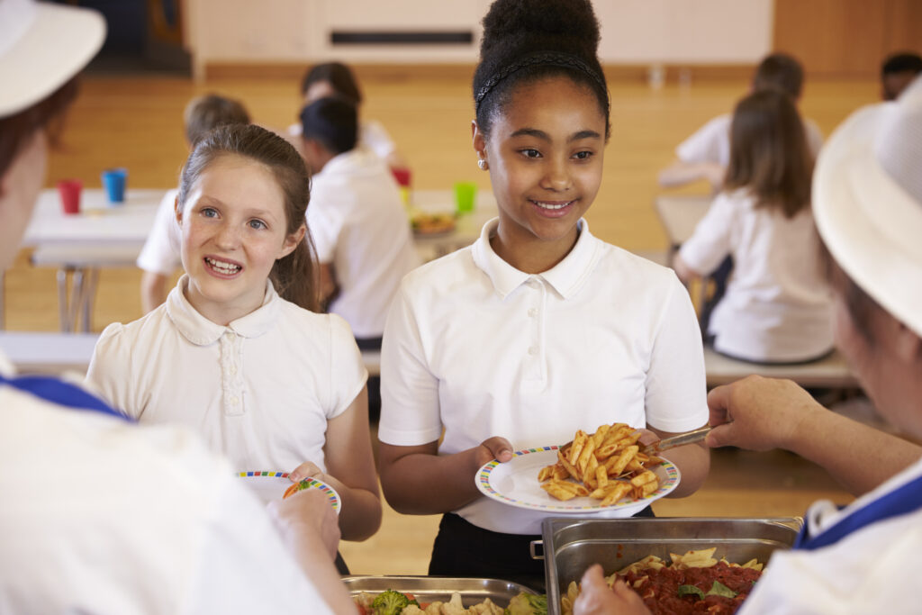 Two girls having a school meal
