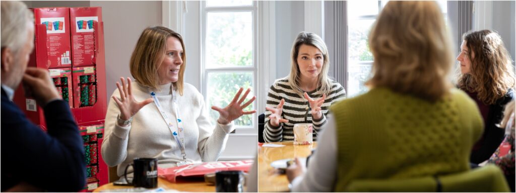 A group of people animatedly chatting around a table